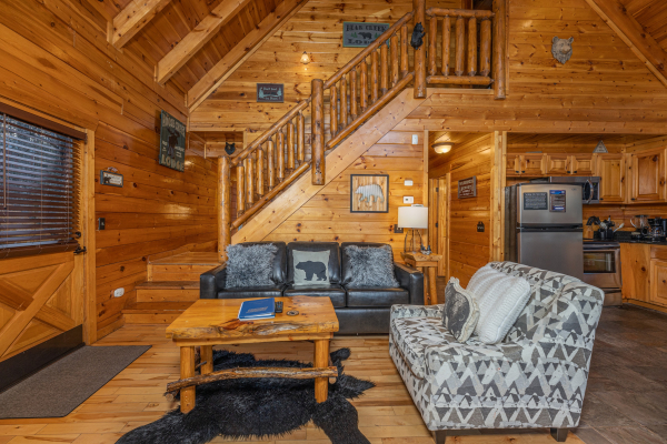 Chair and sofa in a living room A Bear on the Ridge, a 2 bedroom cabin rental located in Pigeon Forge