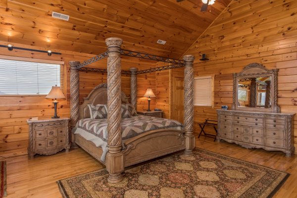 King-sized canopy bed in the loft space at Howlin' in the Smokies, a 2 bedroom cabin rental located in Pigeon Forge