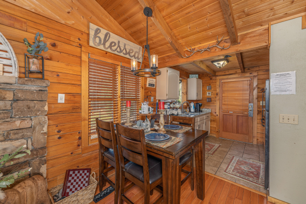 Dining table for four at Snuggle Inn, a 2 bedroom cabin rental located in Pigeon Forge