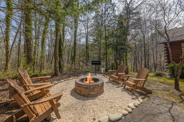 Fire pit in the yard at Snuggle Inn, a 2 bedroom cabin rental located in Pigeon Forge