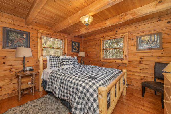 Bedroom with a log bed, night stands, and lamps at Snuggle Inn, a 2 bedroom cabin rental located in Pigeon Forge