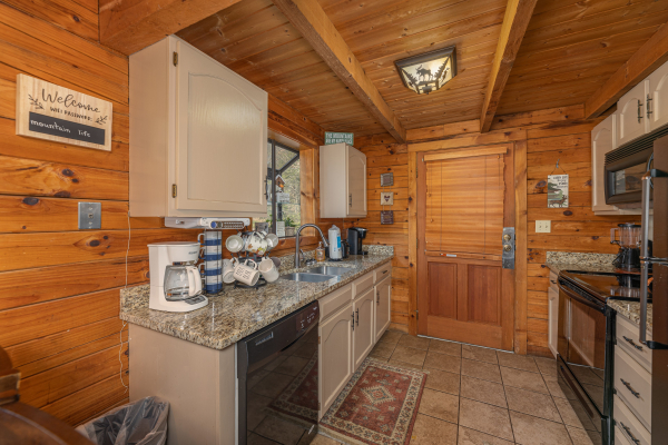 Kitchen with black appliances at Snuggle Inn, a 2 bedroom cabin rental located in Pigeon Forge