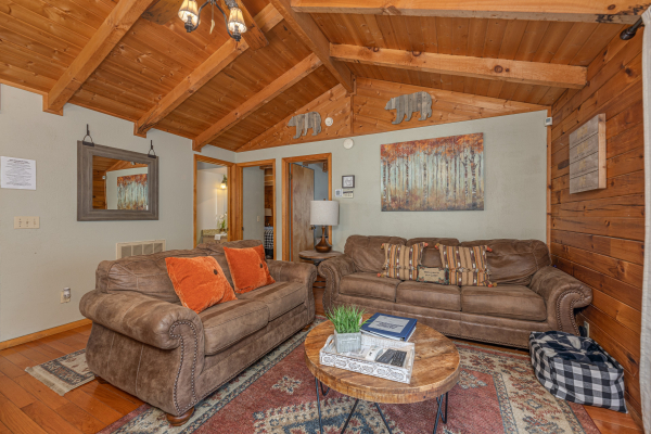 Loveseat and sofa in the living room at Snuggle Inn, a 2 bedroom cabin rental located in Pigeon Forge