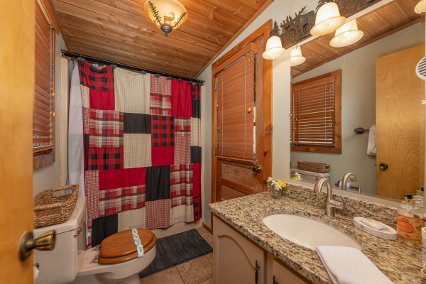Bathroom with a tub and shower at Snuggle Inn, a 2 bedroom cabin rental located in Pigeon Forge