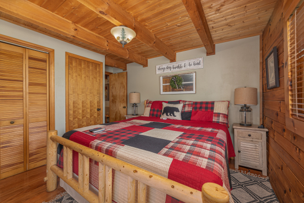 Log bed, two night stands, and lamps at Snuggle Inn, a 2 bedroom cabin rental located in Pigeon Forge