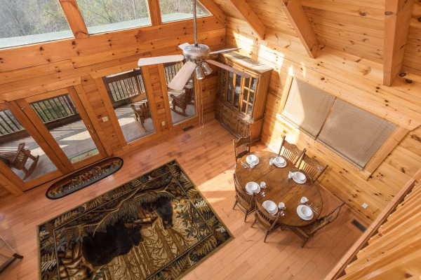 Looking down into the dining space from the upper floor at Leconte View Lodge, a 3 bedroom cabin rental located in Pigeon Forge