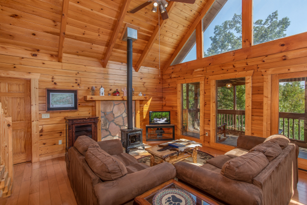Living room with a wood stove and TV at Leconte View Lodge, a 3 bedroom cabin rental located in Pigeon Forge