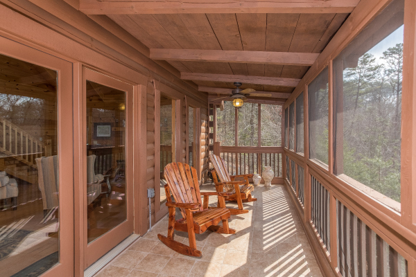 Screened deck with rocking chairs at Leconte View Lodge, a 3 bedroom cabin rental located in Pigeon Forge