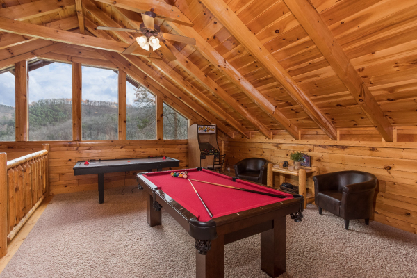 Pool table and air hockey table in the game loft at Mountain View Meadows, a 3 bedroom cabin rental located in Pigeon Forge