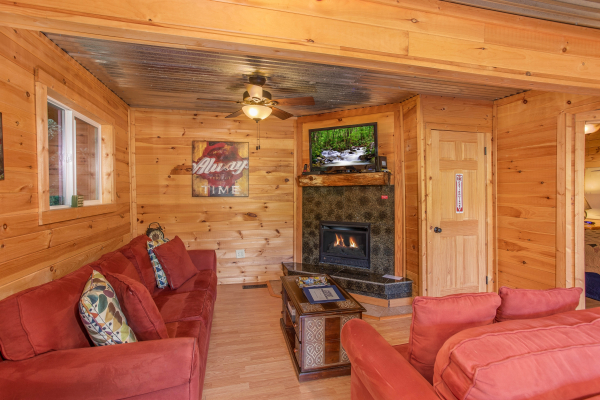 Living room with a corner fireplace and TV at License to Chill, a 3 bedroom cabin rental located in Gatlinburg