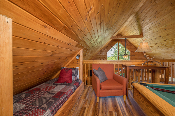 Loft bedroom and gamebook at Eagle's Bluff, a 2 bedroom cabin rental located in douglas lake