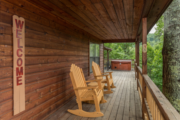 Rocking chairs on the covered deck at Peace & Quiet, a 3 bedroom cabin rental located in Pigeon Forge