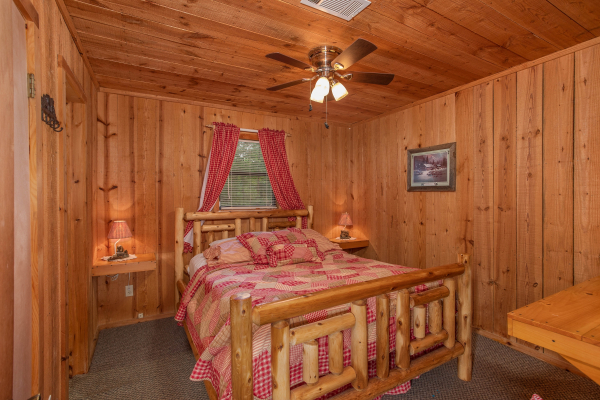 Bedroom with a queen log bed at Peace & Quiet, a 3 bedroom cabin rental located in Pigeon Forge