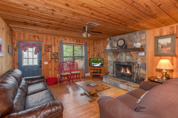 TV and fireplace in the living room at Peace & Quiet, a 3 bedroom cabin rental located in Pigeon Forge