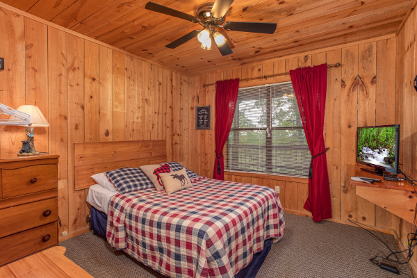 Queen bedroom with dresser and TV at Peace & Quiet, a 3 bedroom cabin rental located in Pigeon Forge