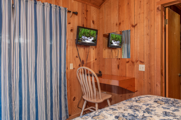 Mirror, desk, and TV in the bedroom at Peace & Quiet, a 3 bedroom cabin rental located in Pigeon Forge