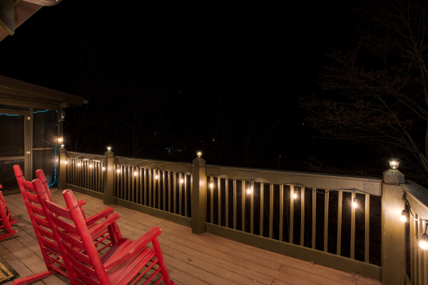 Deck with string lights at Wonders in the Sky, a 3 bedroom cabin rental located in Gatlinburg