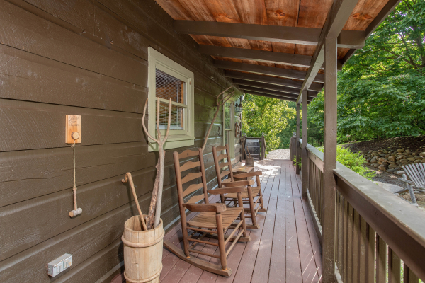 Front porch with rocking chairs at Wonders in the Sky, a 3 bedroom cabin rental located in Gatlinburg