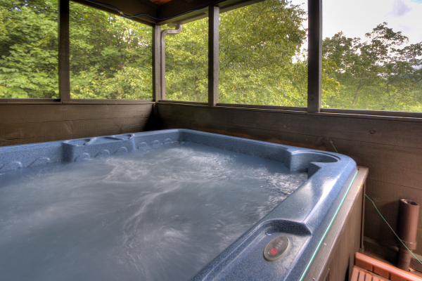 Hot tub on a covered deck at Wonders in the Sky, a 3 bedroom cabin rental located in Gatlinburg