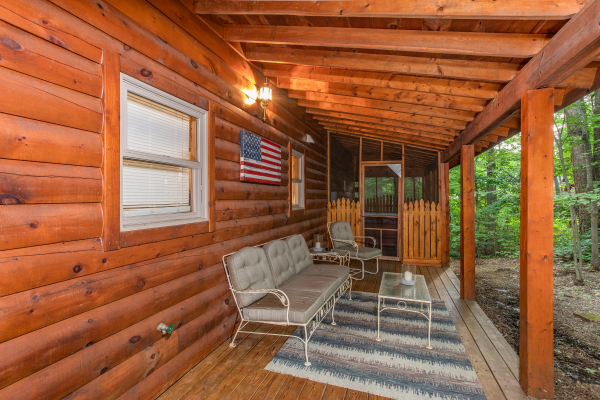 Bench and chair seating on the lower level deck at Lazy Mountain Retreat, a 1 bedroom cabin rental located in Gatlinburg
