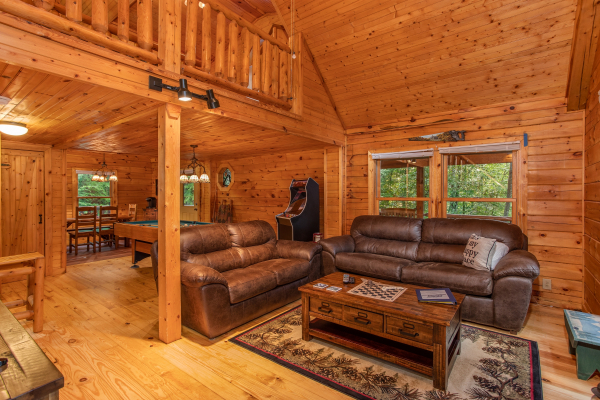 Loveseat and sofa bed in the living room at Lazy Mountain Retreat, a 1 bedroom cabin rental located in Gatlinburg