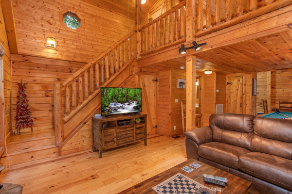 TV on an entertainment console in the living room at Lazy Mountain Retreat, a 1 bedroom cabin rental located in Gatlinburg