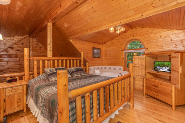 King log bed in the loft space at Lazy Mountain Retreat, a 1 bedroom cabin rental located in Gatlinburg