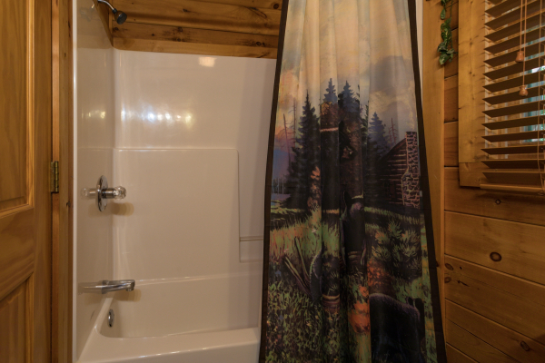 bathroom with a tub and shower at angel's majestic view a 3 bedroom cabin rental located in pigeon forge