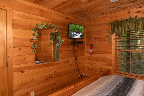 wall mounted television in a bedroom at angel's majestic view a 3 bedroom cabin rental located in pigeon forge