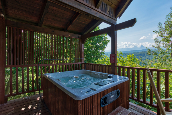 hot tub on a covered deck with mountain views at angel's majestic view a 3 bedroom cabin rental located in pigeon forge