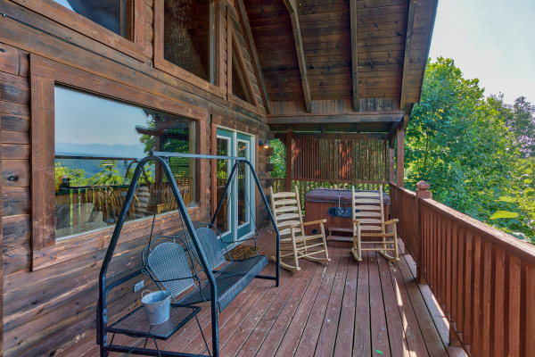 porch swing on a covered deck at angel's majestic view a 3 bedroom cabin rental located in pigeon forge