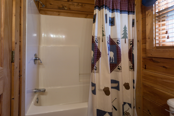 bathroom with tub and shower at angel's majestic view a 3 bedroom cabin rental located in pigeon forge