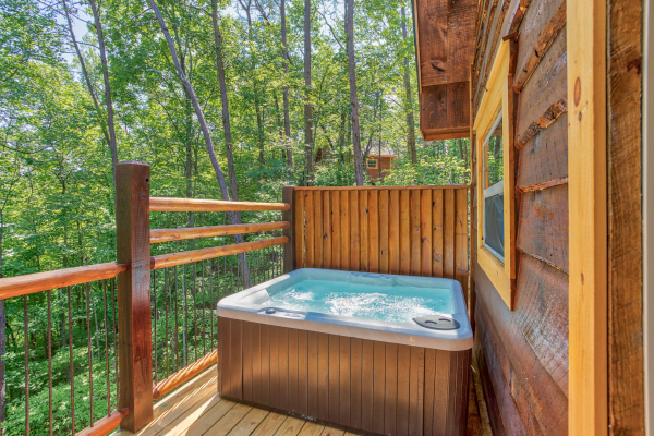 Hot tub and privacy fence on the deck at Out on a Limb, a 1 bedroom cabin rental located in Gatlinburg