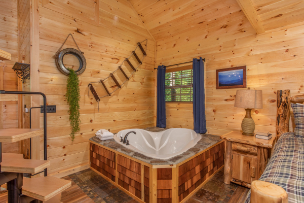 Jacuzzi tub for two in the corner on the main floor at Out on a Limb, a 1 bedroom cabin rental located in Gatlinburg