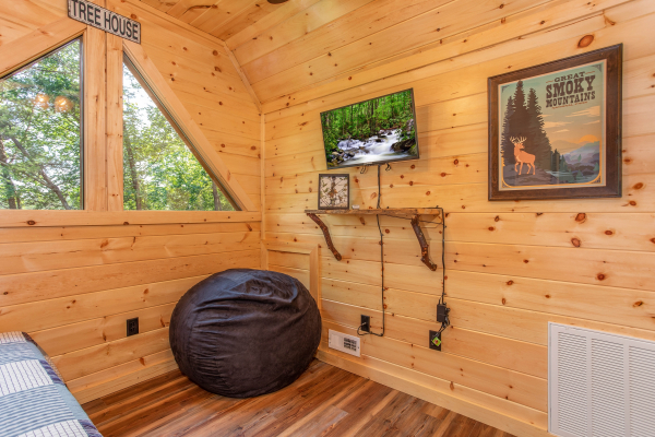 TV and a bean bag chair in the loft space at Out on a Limb, a 1 bedroom cabin rental located in Gatlinburg