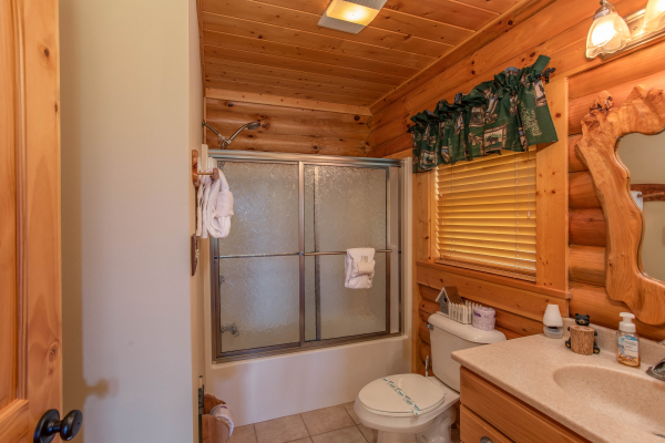 Bathroom with a tub and shower at I Do Love Views, a 3 bedroom cabin rental located in Pigeon Forge