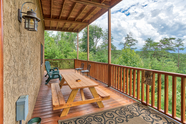 Picnic able on the deck at I Do Love Views, a 3 bedroom cabin rental located in Pigeon Forge