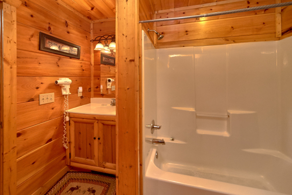 Bathroom with a tub and shower at Pop's Snuggle Bear, a 1 bedroom cabin rental located in Pigeon Forge