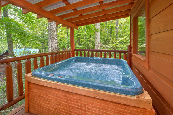 Hot tub on a covered deck at Pop's Snuggle Bear, a 1 bedroom cabin rental located in Pigeon Forge