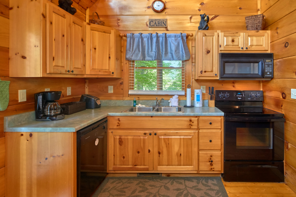 Kitchen with black appliances at Pop's Snuggle Bear, a 1 bedroom cabin rental located in Pigeon Forge