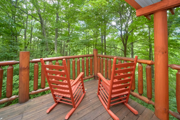 Rocking chairs with a wooded view at Pop's Snuggle Bear, a 1 bedroom cabin rental located in Pigeon Forge
