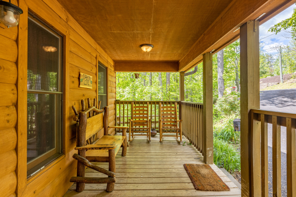 Front porch with bench and rocking chairs at Cabin Life, a 2 bedroom cabin rental located in Pigeon Forge