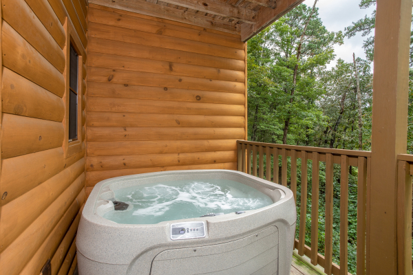 Hot tub on a covered deck at Cabin Life, a 2-bedroom cabin rental located in Pigeon Forge