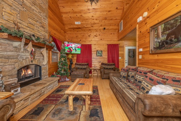 Living room with lots of seating, fireplace, and TV at Cabin Life, a 2 bedroom cabin rental located in Pigeon Forge
