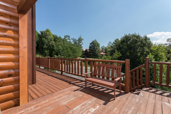 Bench on the deck next to the stairs at Cabin Fever, a 4-bedroom cabin rental located in Pigeon Forge