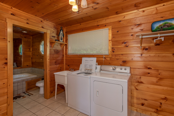 Laundry room with a utility sink, washer, and dryer at Cabin Fever, a 4-bedroom cabin rental located in Pigeon Forge
