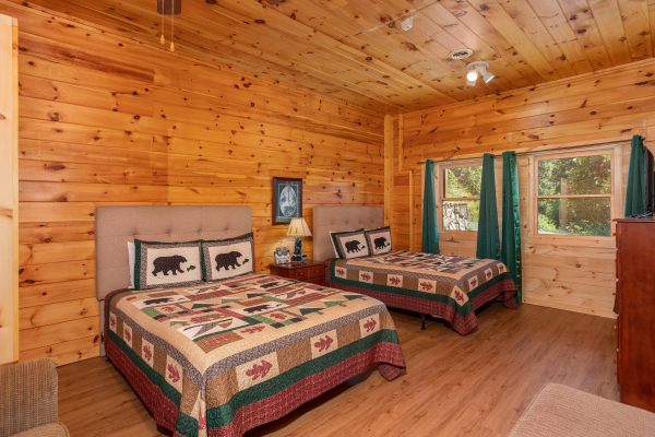 Two queen beds with tufted headboards at Cabin Fever, a 4-bedroom cabin rental located in Pigeon Forge