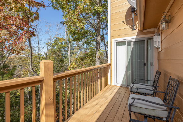 Deck with padded chairs at Into the Woods, a 3 bedroom cabin rental located in Pigeon Forge