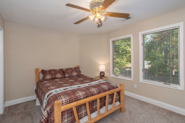 Bedroom with a queen log bed at Into the Woods, a 3 bedroom cabin rental located in Pigeon Forge