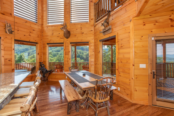 Dining space at the kitchen counter and a large table at Four Seasons Palace, a 5-bedroom cabin rental located in Pigeon Forge